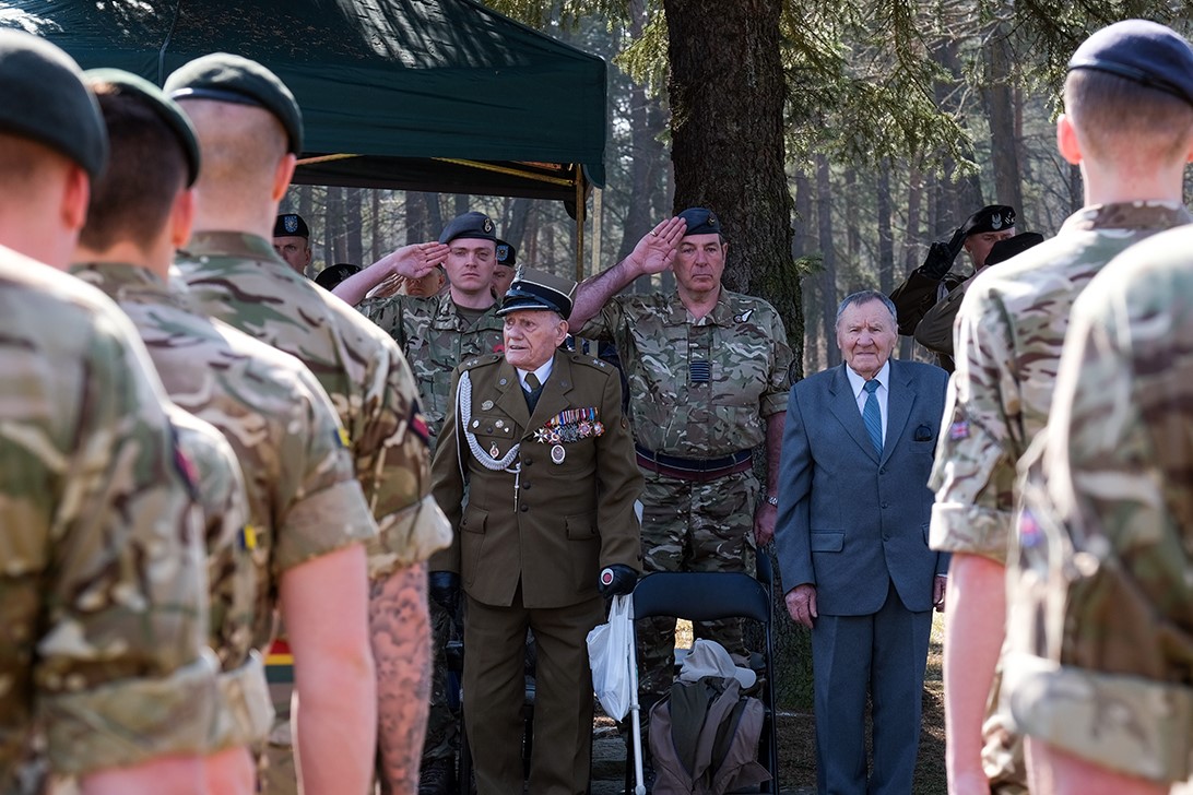 Armed Forces in parade, saluting.